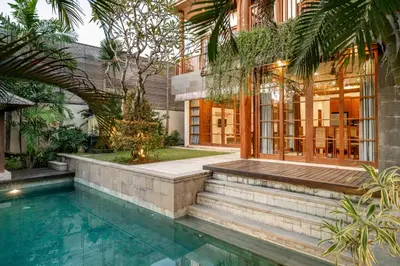 a house with a swimming pool next to a building at Bale Gede Luxury Villas by Moria in Canggu