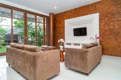 a living room with two couches and a tv at Bale Gede Luxury Villas by Moria in Canggu
