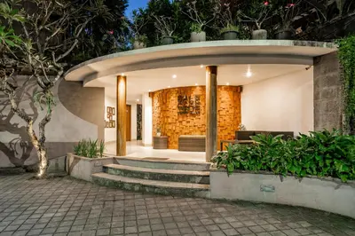 a building with a circular entrance with stairs and plants at Bale Gede Luxury Villas by Moria in Canggu