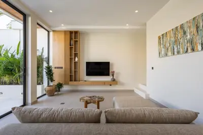a living room with a couch and a tv at Villa Oasia 2 Seminyak in Seminyak
