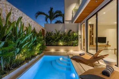 an indoor pool with plants in a house at Villa Oasia 2 Seminyak in Seminyak