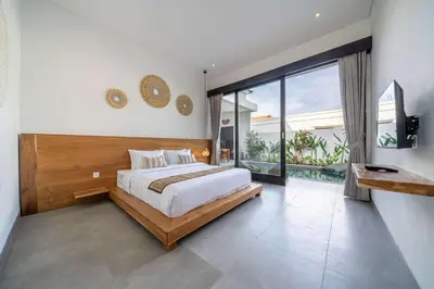 a bedroom with a large bed and a large window at Peaceful 2BR Pool Villa in Kerobokan - V1 in Kerobokan