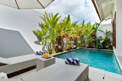 an indoor pool in a villa with a garden at Perfect for Couples and Solo Travellers in Seminyak