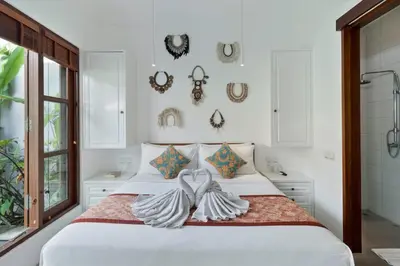 a bedroom with a white bed with two towels at Perfect for Couples and Solo Travellers in Seminyak