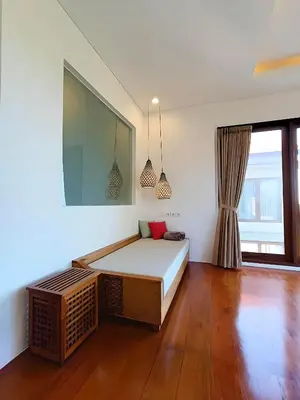 a bedroom with a bed and a large window at SummerVille Nusa Dua by REJA Villas in Nusa Dua