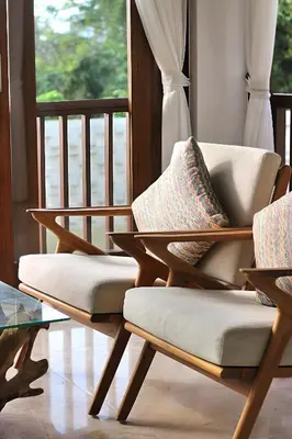 two chairs and a table in a room with a window at SummerVille Nusa Dua by REJA Villas in Nusa Dua