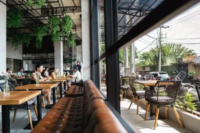 a view of a restaurant with tables and chairs at Nature's Immersion Room at Anwa Bali Boutique Resort in Canggu