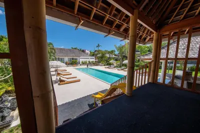 a view of the pool from the porch of a house at Stunning Garden Room with Private Pool at Anwa Bali in Canggu