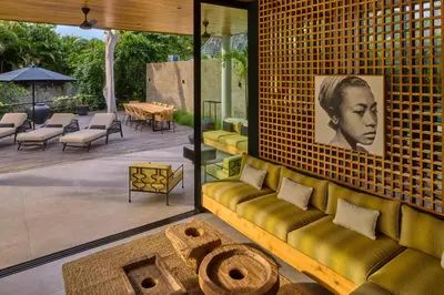 a living room with a couch and a table at The Riverfront 5BR Luxury Villa Near the Beach in Canggu