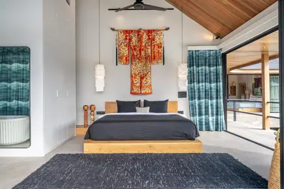 a bedroom with a king sized bed in a room at The Riverfront 5BR Luxury Villa Near the Beach in Canggu