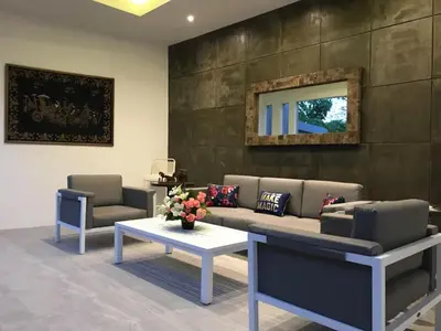 a living room with a couch and two chairs and a table at The Tanjung Bidadari Seminyak in Seminyak
