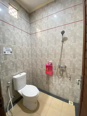 a bathroom with a toilet and a shower at SG Hotel - 2 Minutes to the Beach By Micky Studio 1 in Legian