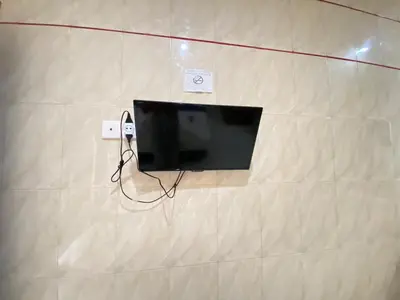 a flat screen tv on a wall at SG Hotel - 2 Minutes to the Beach By Micky Studio 1 in Legian