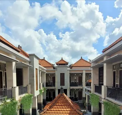 a row of houses with red roofs and a cloudy sky at SG Hotel - 2 Minutes to the Beach By Micky Studio 1 in Legian