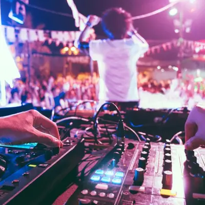 a person playing a mixing console at a concert at SG Hotel - 2 Minutes to the Beach By Micky Studio 1 in Legian