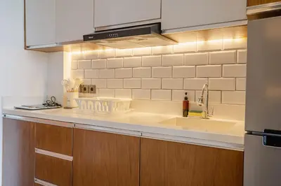 a kitchen with a sink and a counter top at LOI Mansion Managed by ARM One Hundred in Seminyak