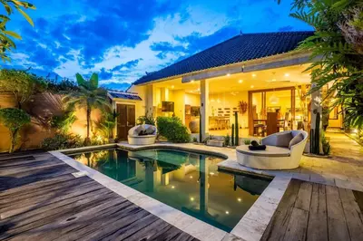 a villa with a swimming pool and a house at Villa CC- Cosy 2bdrs villa - enclosed and open living area in Seminyak