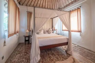 a bedroom with a bed with a canopy at Two bedroom Villa in a beautyful tropical garden in Seminyak