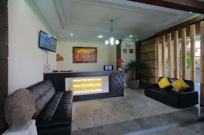 a living room with a couch and a fireplace at Lotus Tirta Seminyak in Seminyak