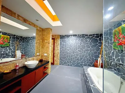 a bathroom with a tub and a sink and a bath tub at Brady's 3 bedrooms Villa Center of Sanur in Sanur