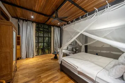 a bedroom with a canopy bed and a wooden ceiling at 4 Bedrooms Brand New serenity Villa in Seminyak