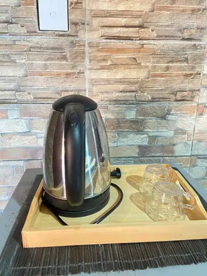 a tea kettle sitting on a tray on a table at ABI Hotel - 1 minute to the Beach and 1 second to the Mall in Ngurah Rai International Airport