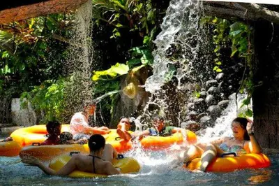 a group of people in the water at a waterfall at ABI Hotel - 1 minute to the Beach and 1 second to the Mall in Ngurah Rai International Airport