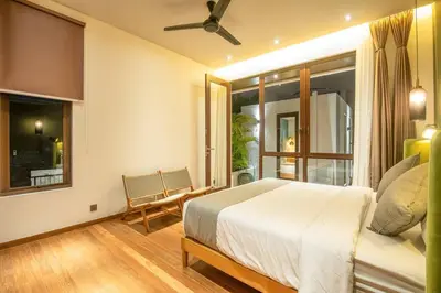 a bedroom with a bed and a window at Chic Modern 3BR Villa, Enclosed Living Room in Canggu