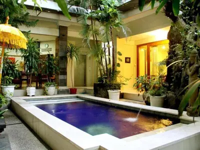 a large swimming pool in a house with plants at SC Hotel - 1 Minute to the Beach By Micky Studio in Badung