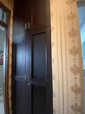 a black cabinet with a door next to a wall at SC Hotel - 1 Minute to the Beach By Micky Studio in Badung