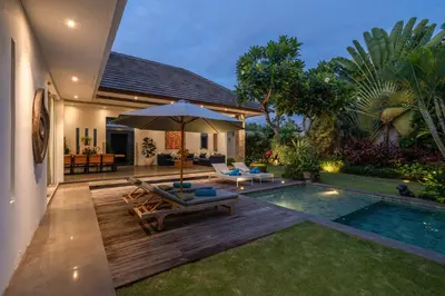 a backyard with a swimming pool and a villa at Incredible 3BR Villa In The Heart Of Seminyak in Seminyak