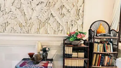 a living room with a table and some books at Cempaka Villa in Pesanggaran