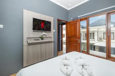a bedroom with a bed with two towels at Rivera Seminyak 1 in Seminyak
