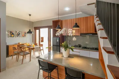 a kitchen and dining room with a dining table at Rivera Seminyak 1 in Seminyak