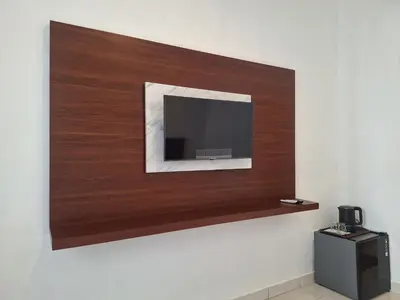 a flat screen tv mounted on a wall at Saphala Suites Seminyak in Seminyak