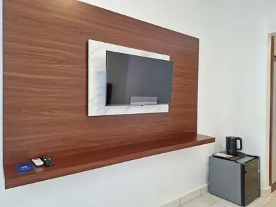 a flat screen tv mounted on a wall at Saphala Suites Seminyak in Seminyak