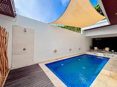 a swimming pool in a house with a skylight at Budayana Villa in Jimbaran