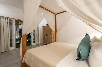 a bedroom with a bed with a canopy at Central Oberoi Seminyak Newly Renovated Villa Riva in Seminyak