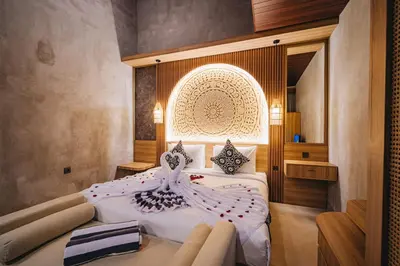 a bedroom with a large bed with white sheets at iRini Villas in Nusa Dua