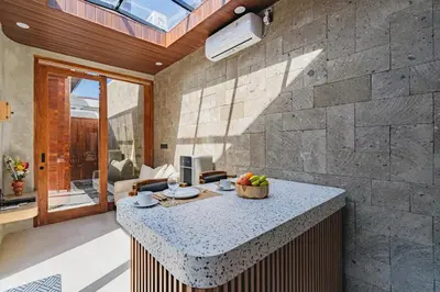 a kitchen with a island in a living room at iRini Villas in Nusa Dua