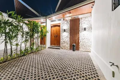 a hallway with a wooden door and plants at iRini Villas in Nusa Dua