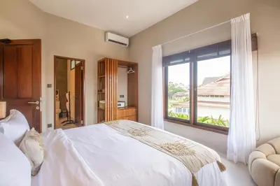 a bedroom with a large white bed and a window at 4 Bd Seminyak Scenic Rice Views 4 mins to Beach in Seminyak