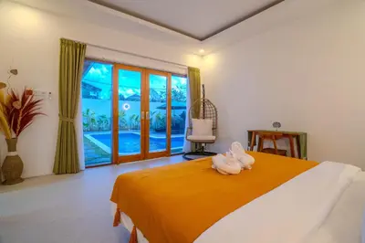 a bedroom with a bed with a stuffed animal on it at Villa Radha Seminyak in Seminyak