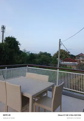 a table and chairs sitting on a balcony at Lucky Villa Jimbaran Penta in Jimbaran