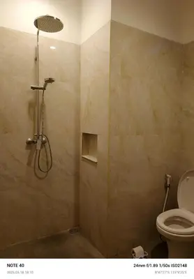 a bathroom with a shower with a toilet at Lucky Villa Jimbaran Penta in Jimbaran