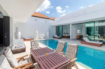 a villa with a swimming pool and a house at Stylish 3BR Villa with Swim-Up Bar in Seminyak in Seminyak