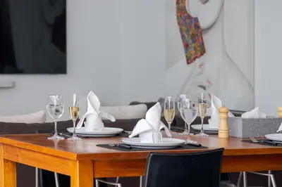 a table with wine glasses and napkins on it at Stylish 3BR Villa with Swim-Up Bar in Seminyak in Seminyak
