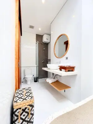 a bathroom with a sink and a mirror at Villa De Tutti - 2BR Pool Villa Near Seminyak in Seminyak