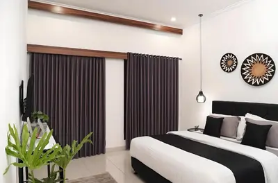 a bedroom with a large bed and a large window at Villa Mimoza Umalas Bali in Kerobokan