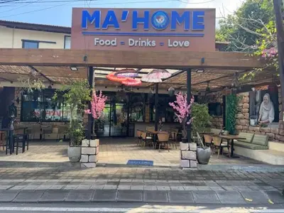 a restaurant with tables and chairs in front of it at Mahome - Near Finn's and Atlas Beach Club in Canggu